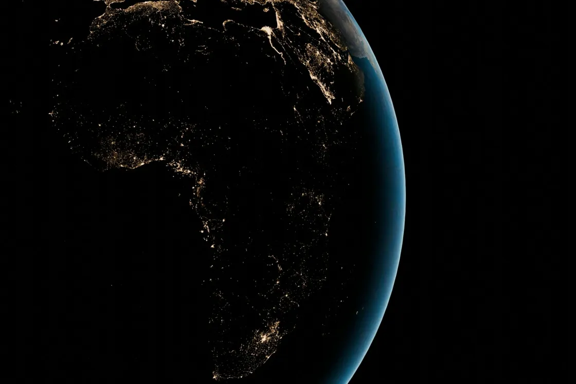 Africa and the Middle East at night from space, with city lights highlighting hubs across North, West, East, and Southern Africa and the Gulf.