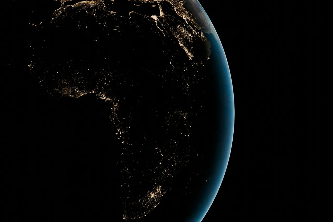 Africa and the Middle East at night from space, with city lights highlighting hubs across North, West, East, and Southern Africa and the Gulf.